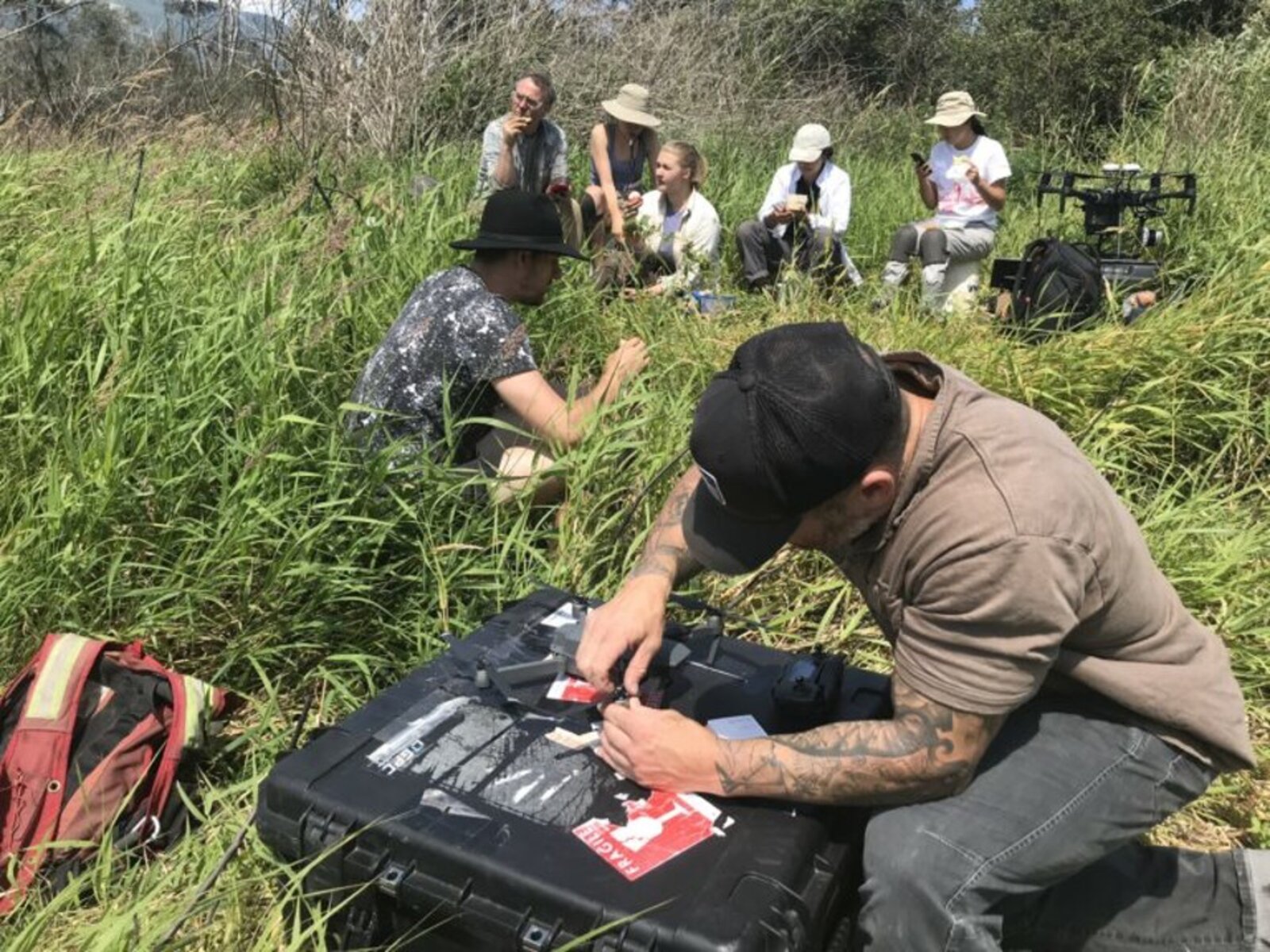 Field team preparing drone equipment for a habitat survey